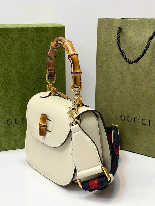 Women Gucci Sylvie bags with a monogram - embossed leatherGucci Bamboo 1947 mini top handle bag white