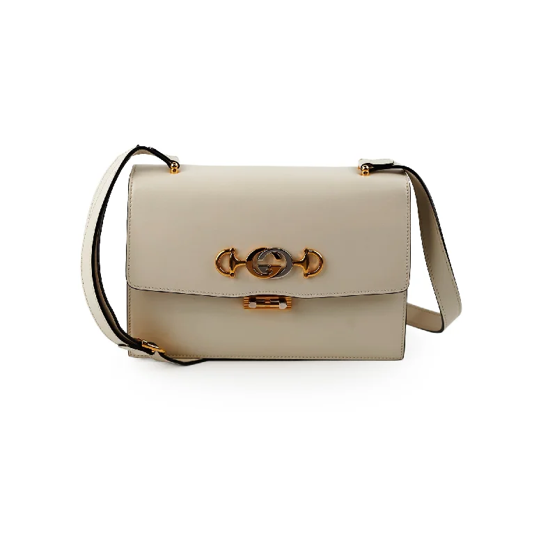 Women Gucci crossbody bags with a woven leather strapGucci Lock Logo Cream Crossbody Bag