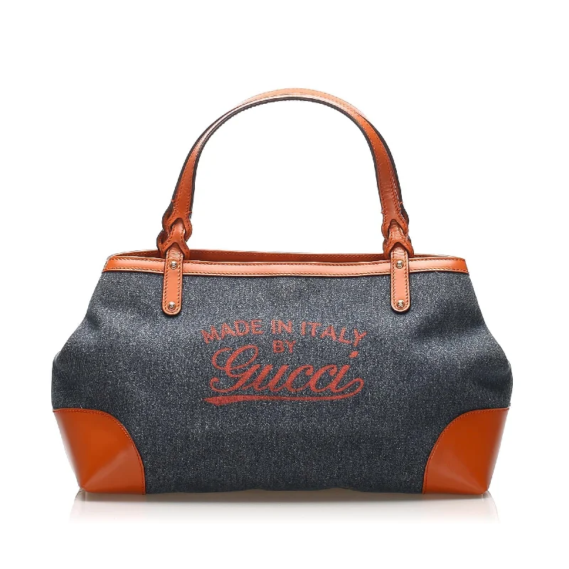 Women Gucci bags with a snap - button closure and a decorative charmGucci Craft Denim Tote Bag (SHG-11937)