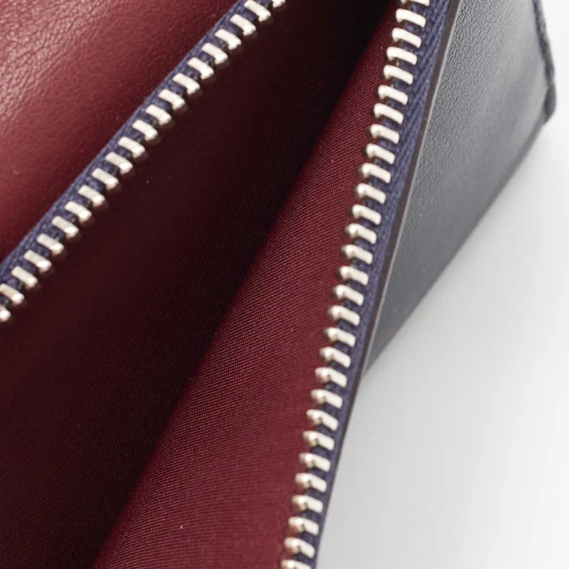 Contemporary Christian Dior handbags with a unique shapeChristian Dior Burgundy/Dark Blue Leather issimo Envelope Wallet